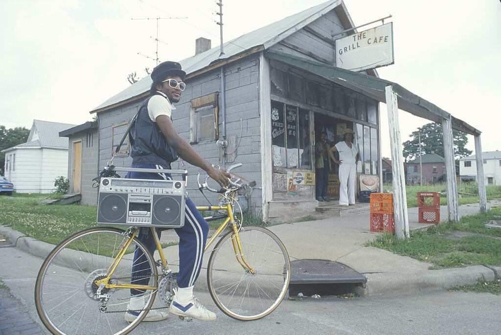 A young African-American man on his bicycle with his boom box, Cairo, IL, 1985