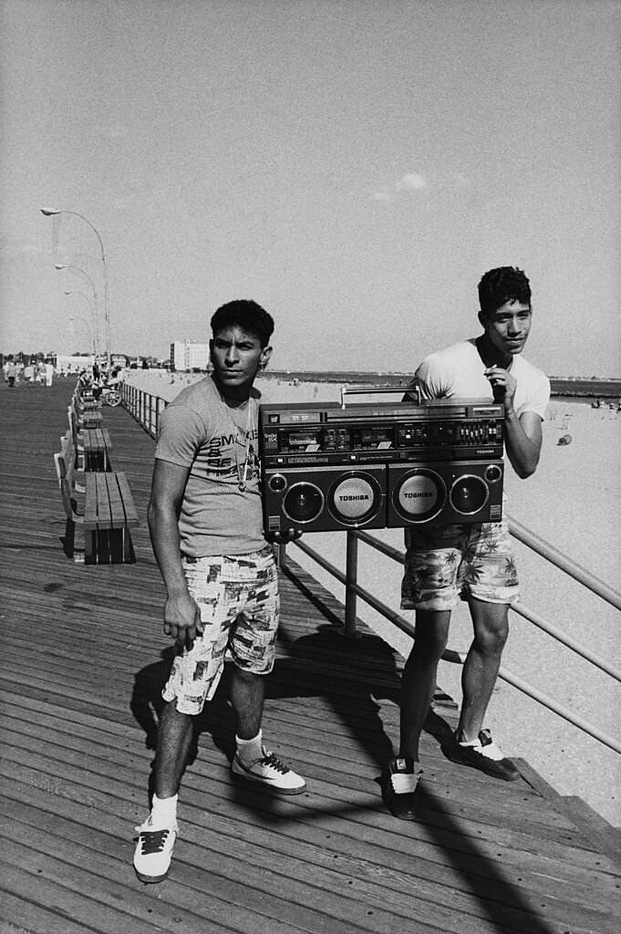 Two black teenagers dressed in Adidas tracksuits, with a stylish boombox, 1986