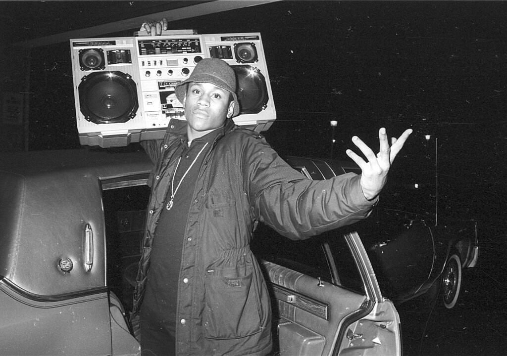 LL Cool J holds a boombox outside a concert, circa 1986