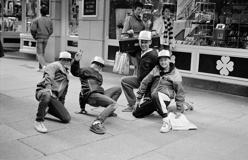 A young group of B Boy kids posing in the street with a boombox, Guernsey, 1986