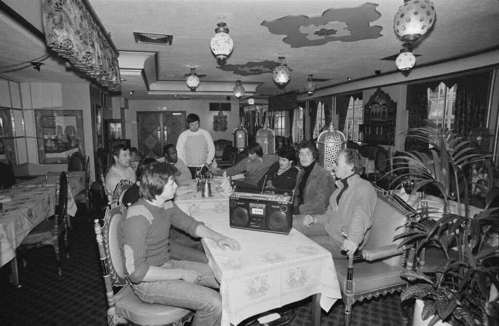 A group of men at the Veeraswamy Restaurant with boombox in London, 1980