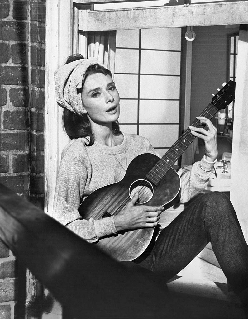 Audrey Hepburn playing guitar