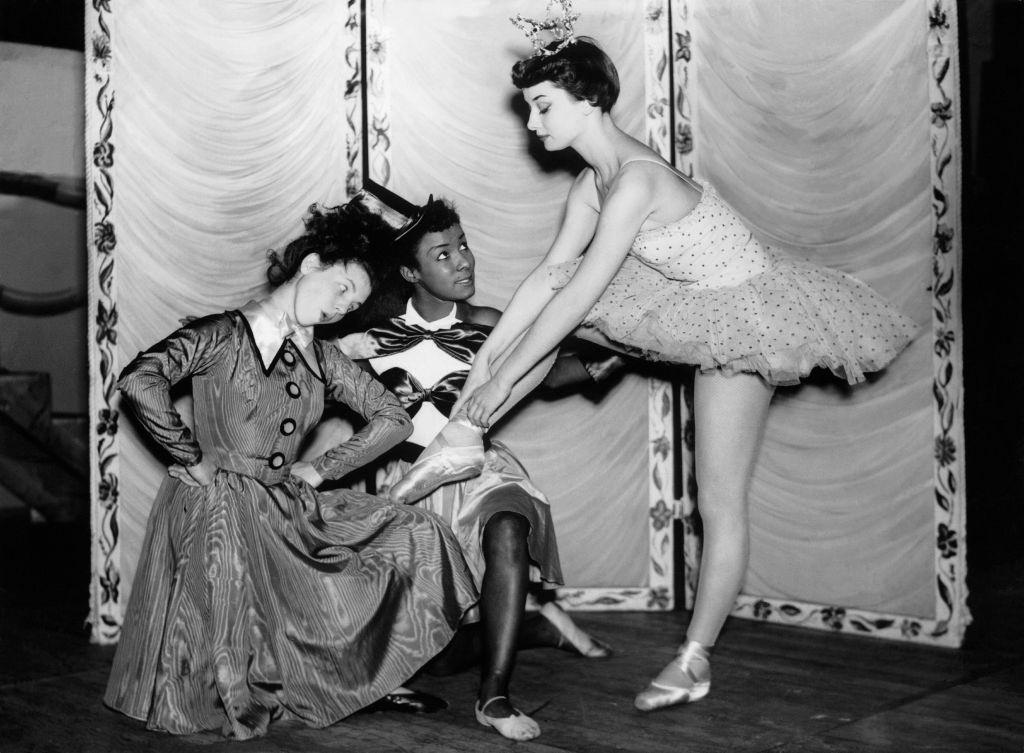 Audrey Hepburn playing the role of a Christmas doll during rehearsals for a children's show at the Cambridge theater, December 1949.