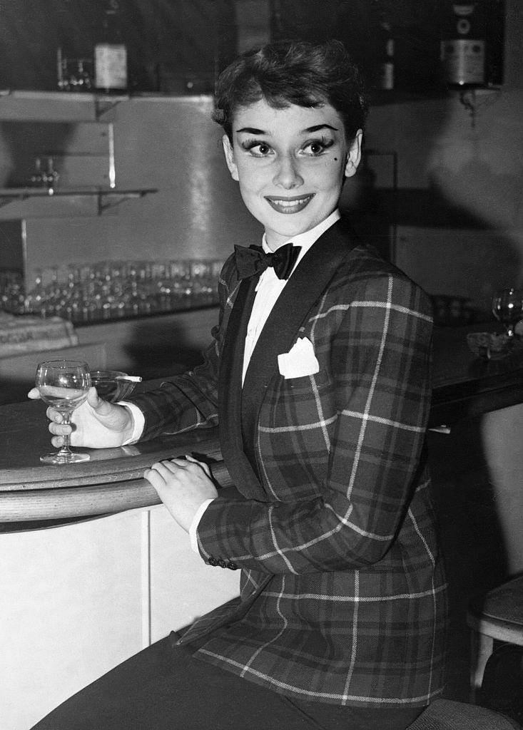 Audrey Hepburn wearing a tartan dinner jacket, 1950.