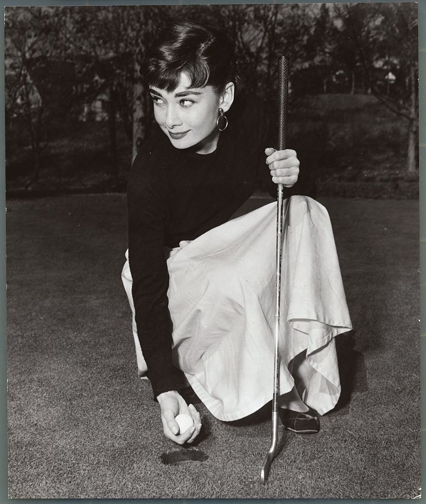 Audrey smiles after a successful putt.