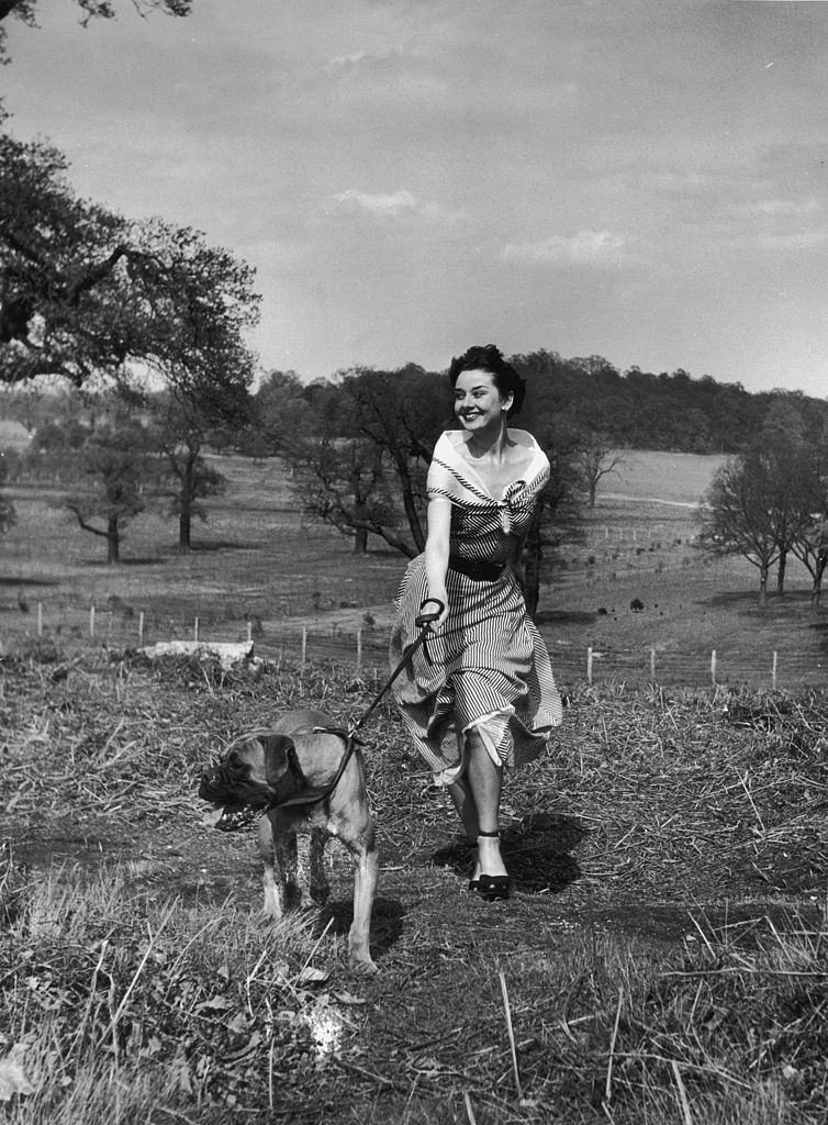 Audrey Hepburn exercising her dog in Richmond Park, May 1950.