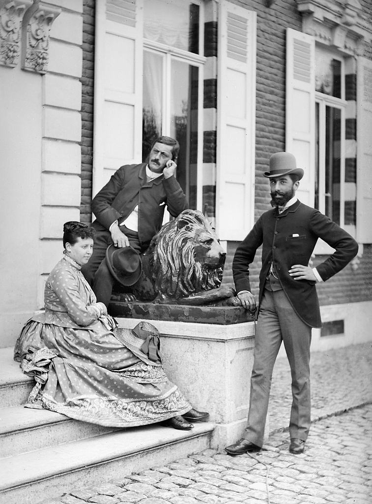 Wealthy couple portrait at the door to the chateau in Belgium, 1900.