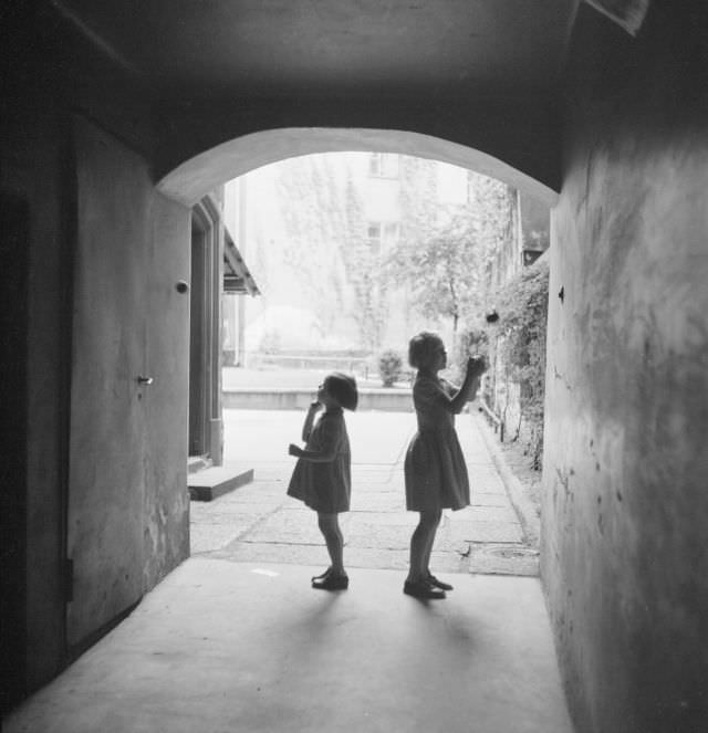 Two little girls throwing balls in a vault in Cepheus neighborhood, Gamla stan.