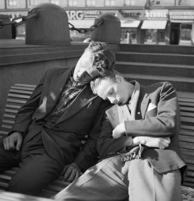 Two young men having a nap in a sunny day down at the lock.