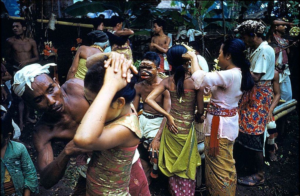 Balinese women dancers are helped to dress and make up, 1956.