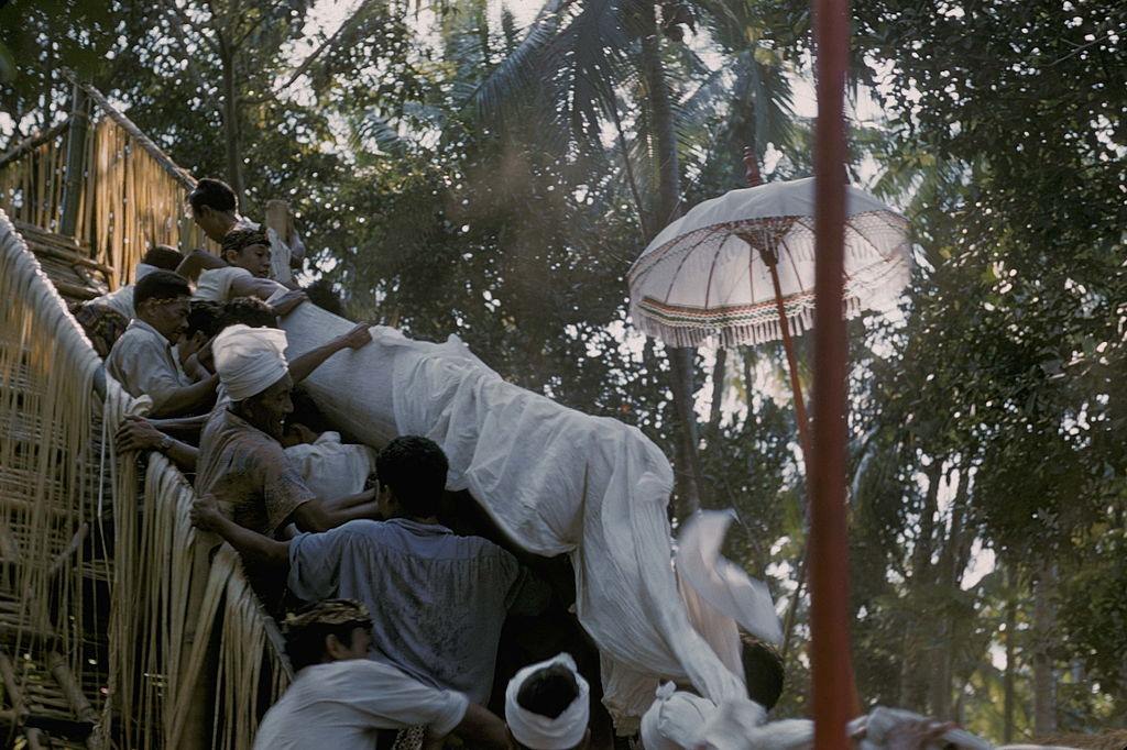 People carrying the coffin during a cremation, Bali, 1957.