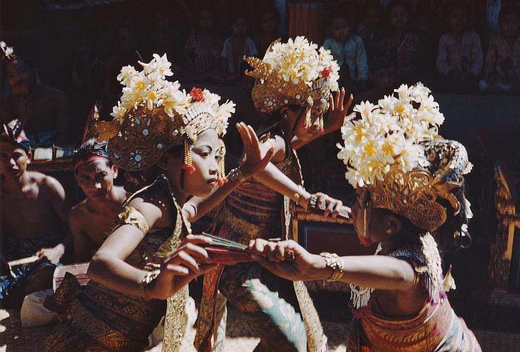Creamy white flowers decorate the ornate headresses of female dancers in Bali, 1956.