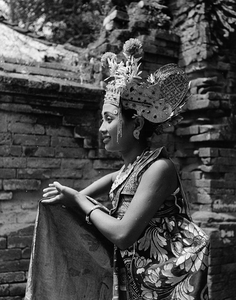 A dancer in traditional Balinese costume performs, 1950.