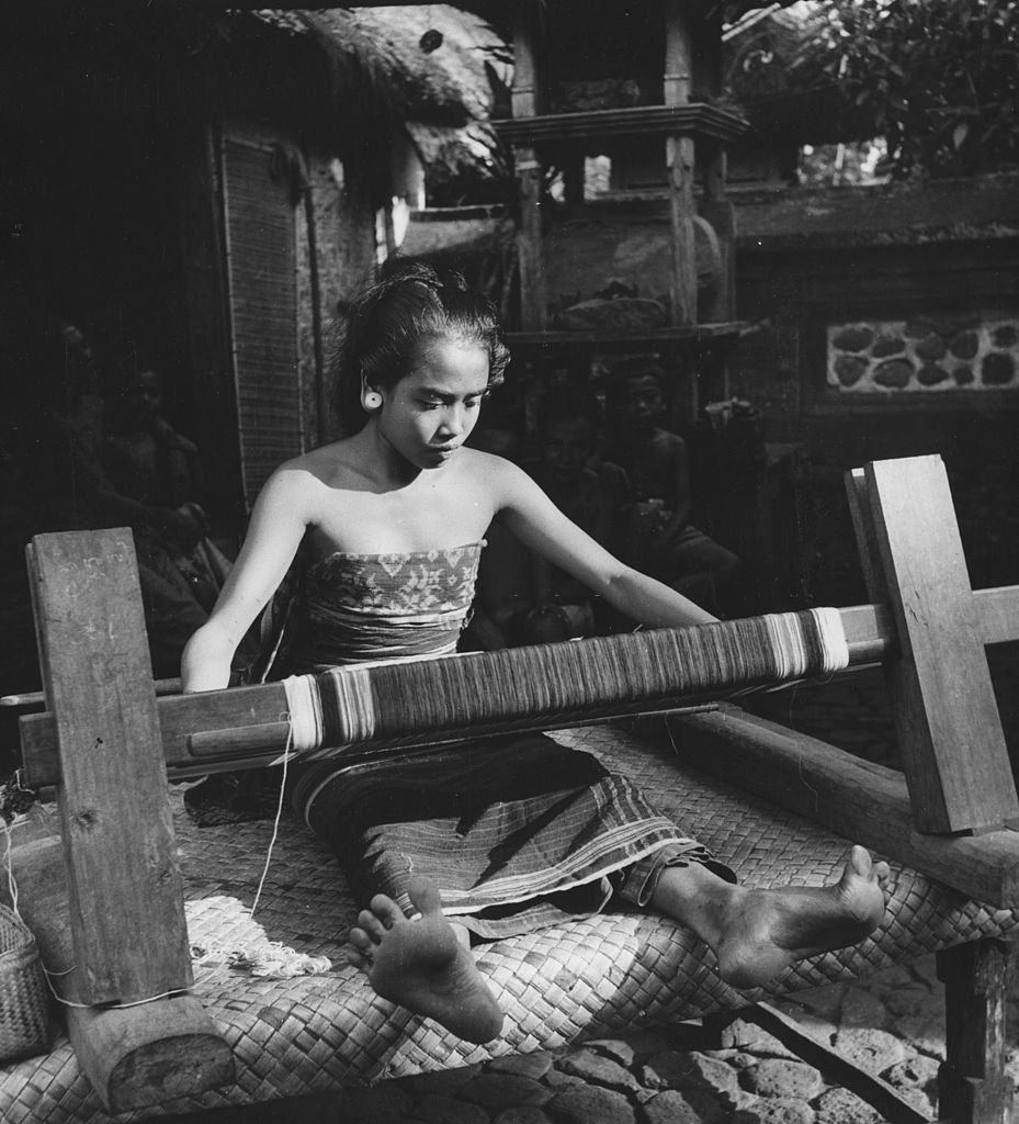 The daughter of a village headman weaving a sarong in Bali, 1954.