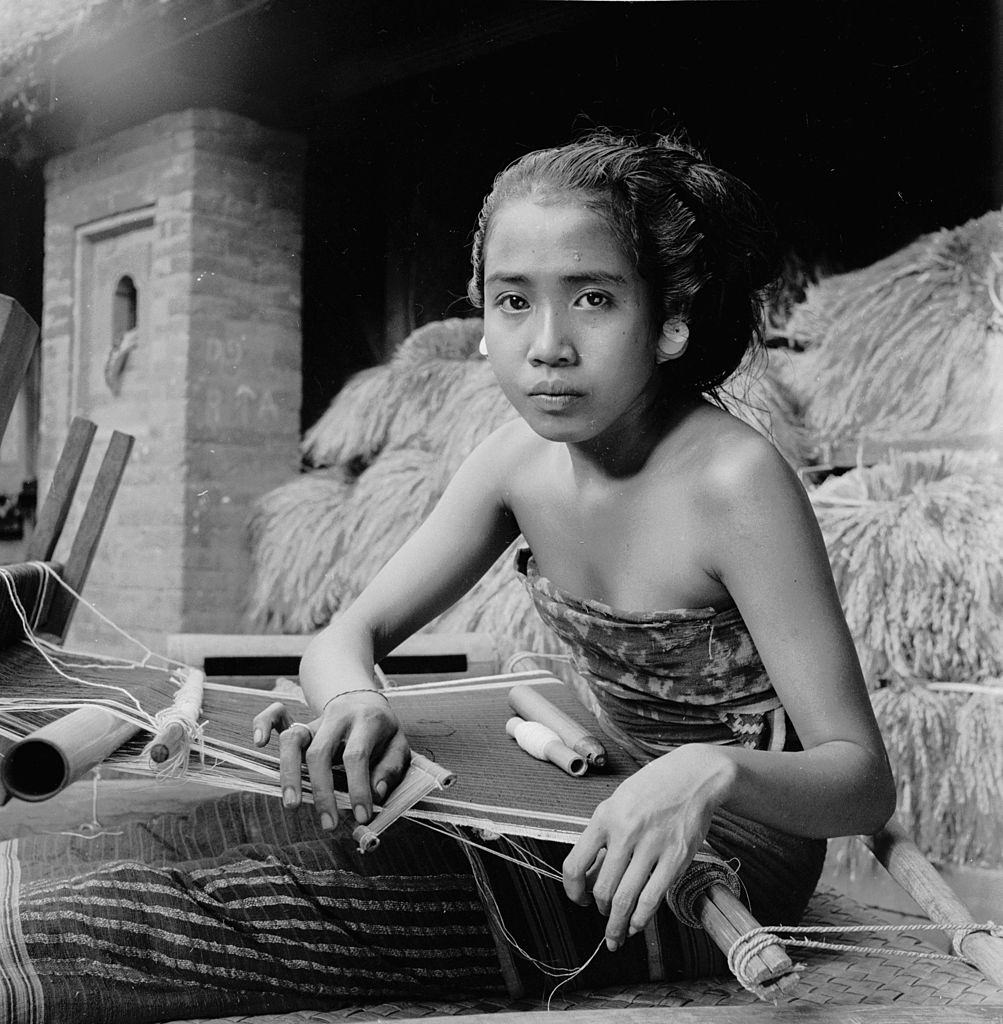 An Indonesian woman weaving on the island of Bali, 1955.