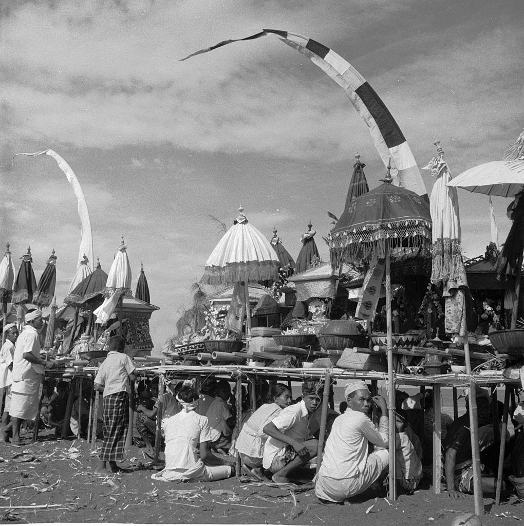 Shrines being carried to the seashore on the island of Bali, Indonesia, during an annual religious festival, 1955.