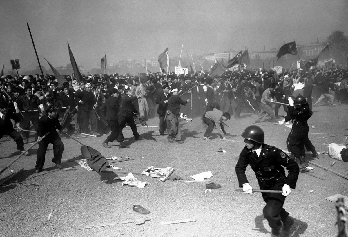 Pro-communist demonstrators stone Japanese policemen at the height of May Day riots in downtown Tokyo on May 1, 1952.