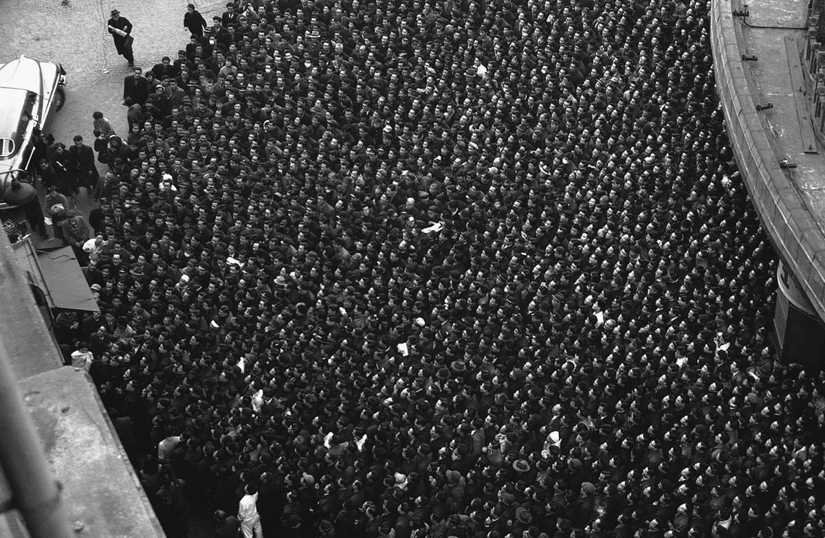 A combination of two comparative novelties to Japanese audiences, television and American wrestling, brought out a tremendous crowd of fans watching the bouts on an outdoor screen in Tokyo on February 21, 1954.