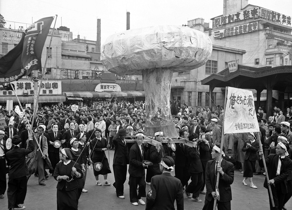 A huge replica of an H-bomb mushroom cloud is carried through the streets of Tokyo, Japan, on May 1, 1957, in protest of a planned British H-bomb test at Christmas Islands.
