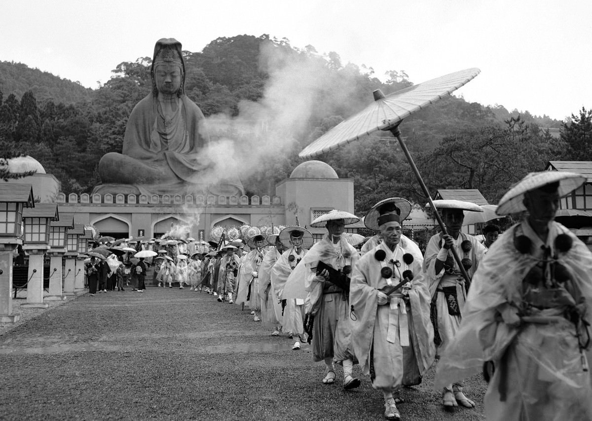 Some 50 colorfully-garbed Buddhist monks march from the Buddhist goddess of Mercy Statue in Kyoto, Japan on May 11, 1958, after the unveiling of a memorial to Allied dead of World War II on June 8.