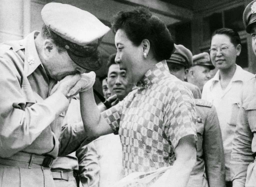 Gen. Douglas MacArthur kisses the white-gloved hand of Madame Chiang Kai-shek on August 7, 1950