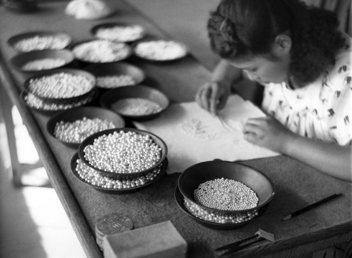 A Japanese girl carefully sorts cultured pearls raised on Kokichi Mikimoto's pearl farm near the tip of Japan's Ise peninsula on October 12, 1949.