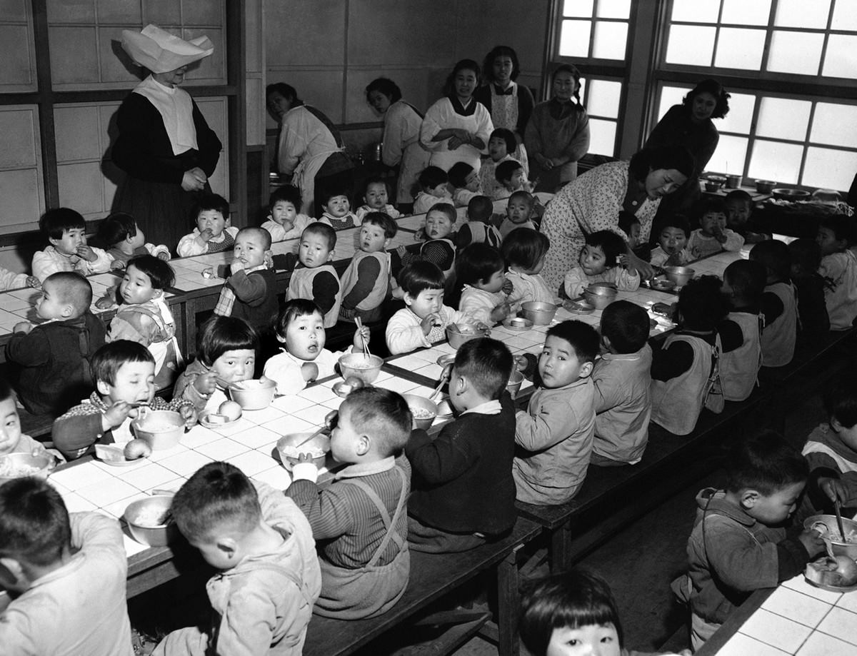 Dining room of an orphanage in Osaka, Japan, on February 19, 1951, where the 160 orphans were fed each day on food purchased by the Wolfhounds, the 27th Infantry Regiment of the U.S. Army.