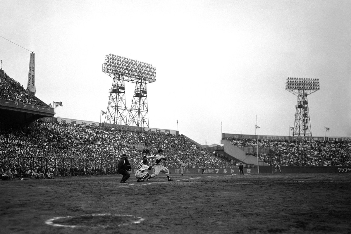 Dom DiMaggio of the Boston Red Sox gets set to swing during an exhibition game between the American All-Stars and the Yomiuri Giants in Japan on October 20, 1951.