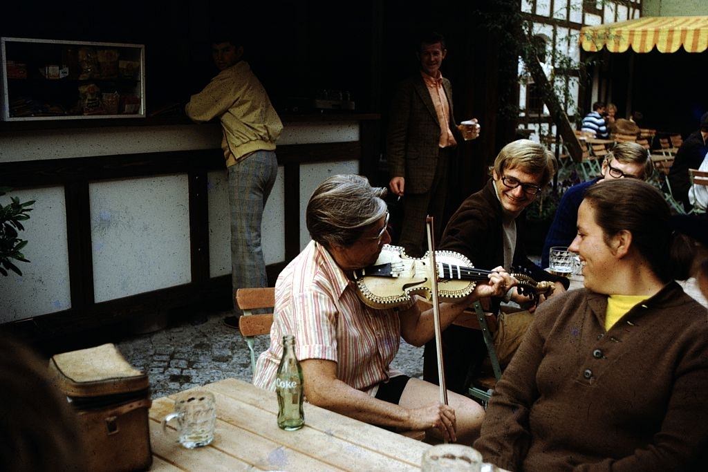 Woman playing a fiddle in a cafe, Ireland, 1960.