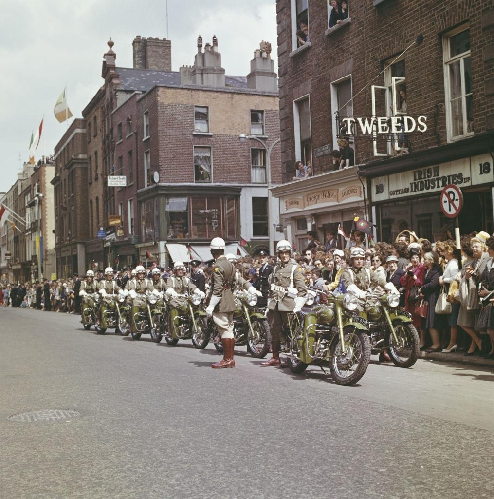 Garda police motorcyclistswaiting along with residents and spectators on a Dublin street for the arrival of Prince Rainier and Princess Grace of Monaco during their State Visit to Ireland in June 1961.