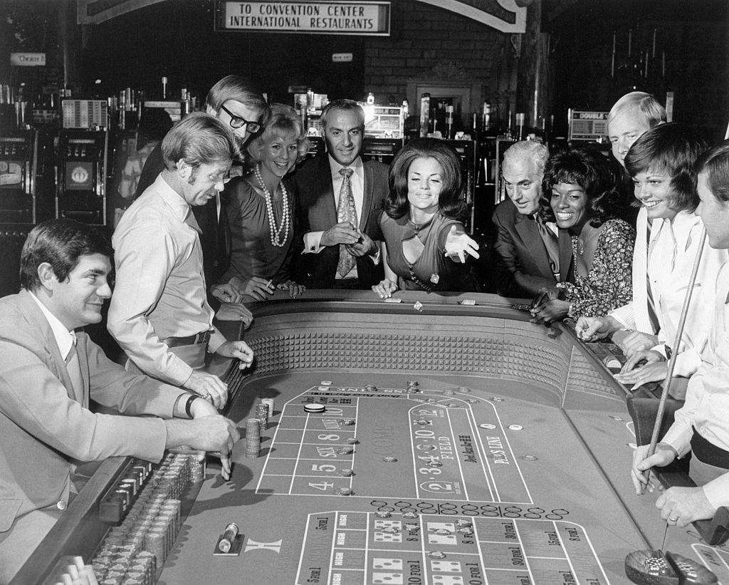 Woman throwing dice at a Craps Table, Las Vegas, 1960s.