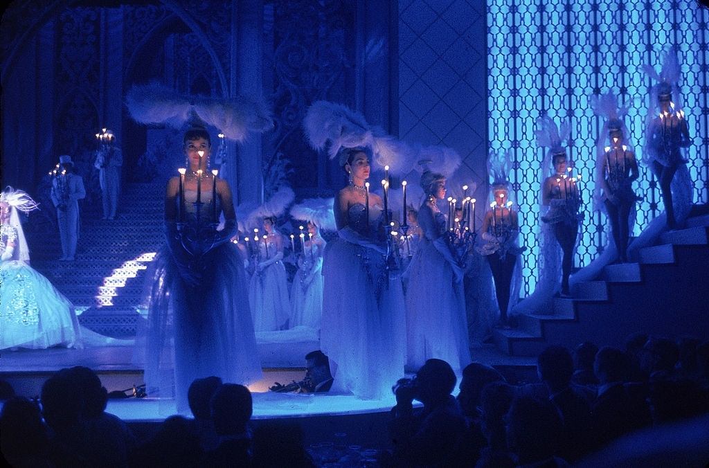 Showgirls stand on stage with candelabra in their hands during a performance of 'Romantic Reverie,'at the Tropicana Hotel, Las Vegas, 1960.