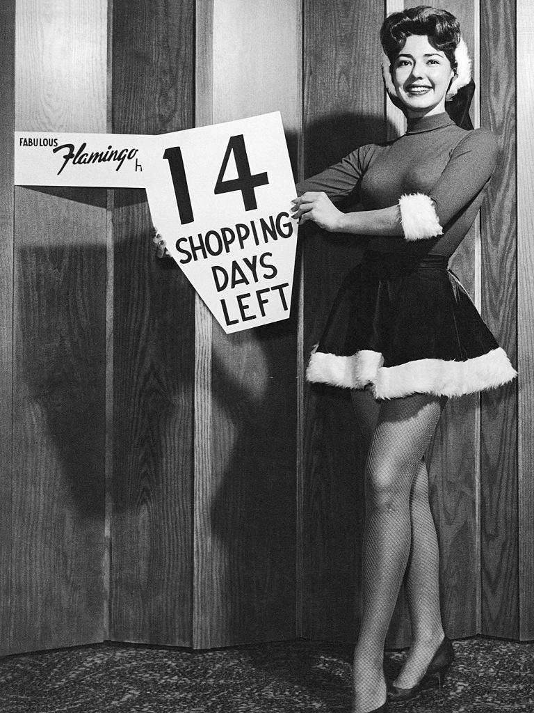 A lovely Jean Gardner of the Flamingo Hotel reminds you that there are only 14 shopping days left before Christmas, Las Vegas, 1960s.
