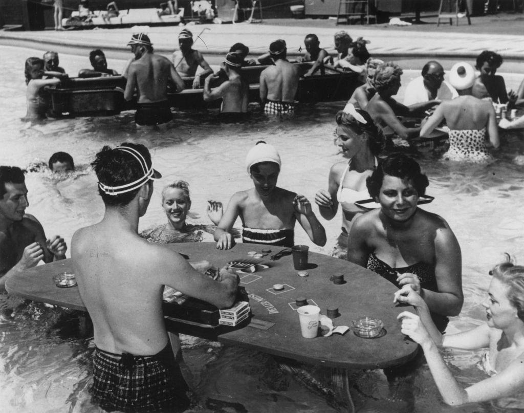 A croupier dealing a hand at a swimming pool casino at the Sands Hotel in Las Vegas, 1965.