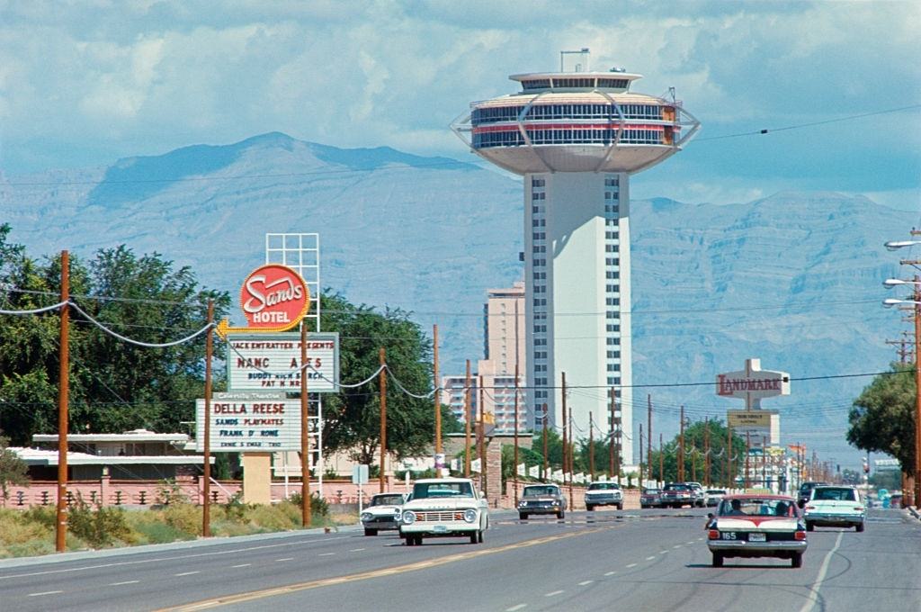 View of hotels alongside the road, including the Sands Hotel and the Landmark Hotel, Las Vegas, 1968.