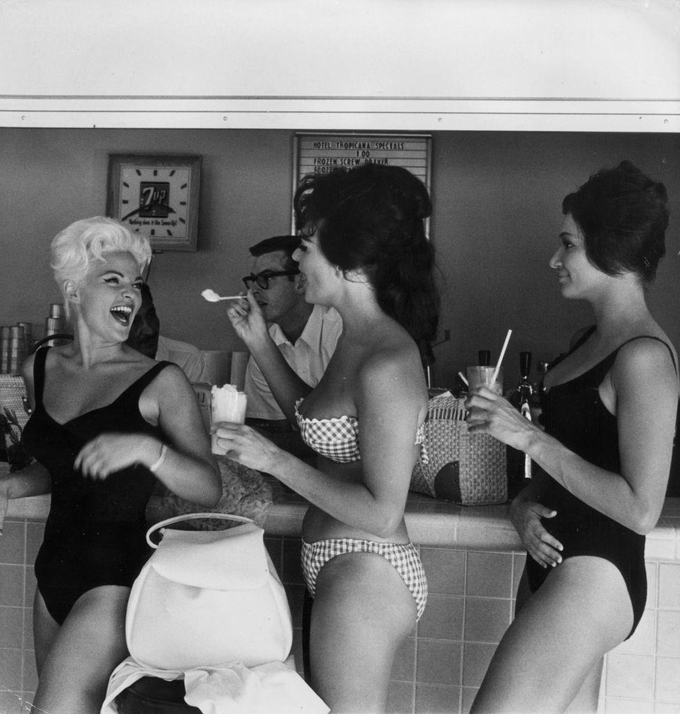 Bathing beauties enjoy iced drinks in a bar in Las Vegas, 1960.