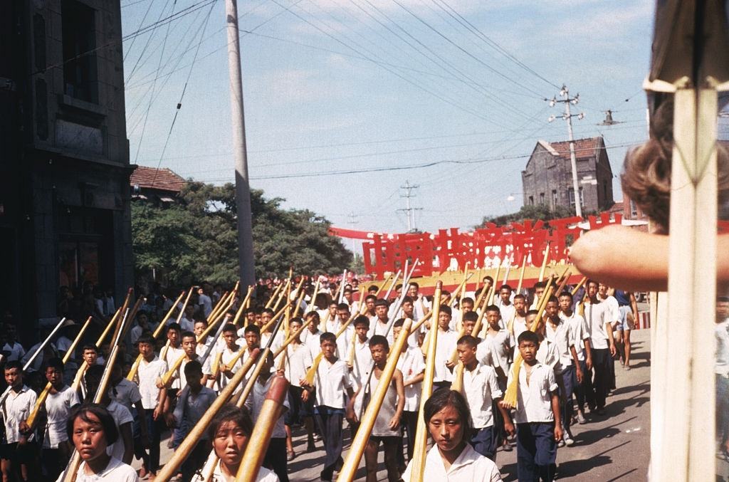 Young Red Guards march with wooden rifles.