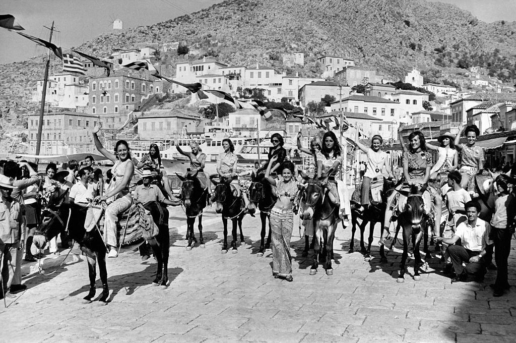 Candidates to the Miss Europe 1970 beauty contest taking part in a race of donkeys in Hydra Island, Greece.