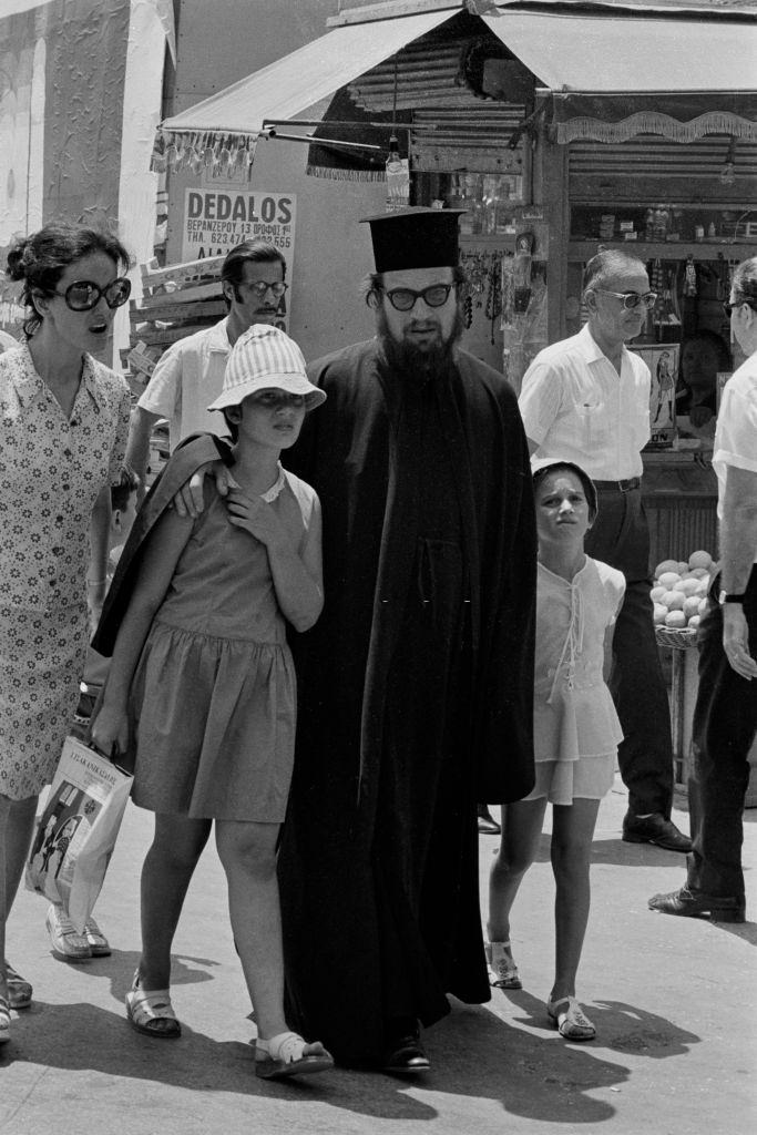 Orthodox priest and his family on a street in Athens in July 1973, Greece.