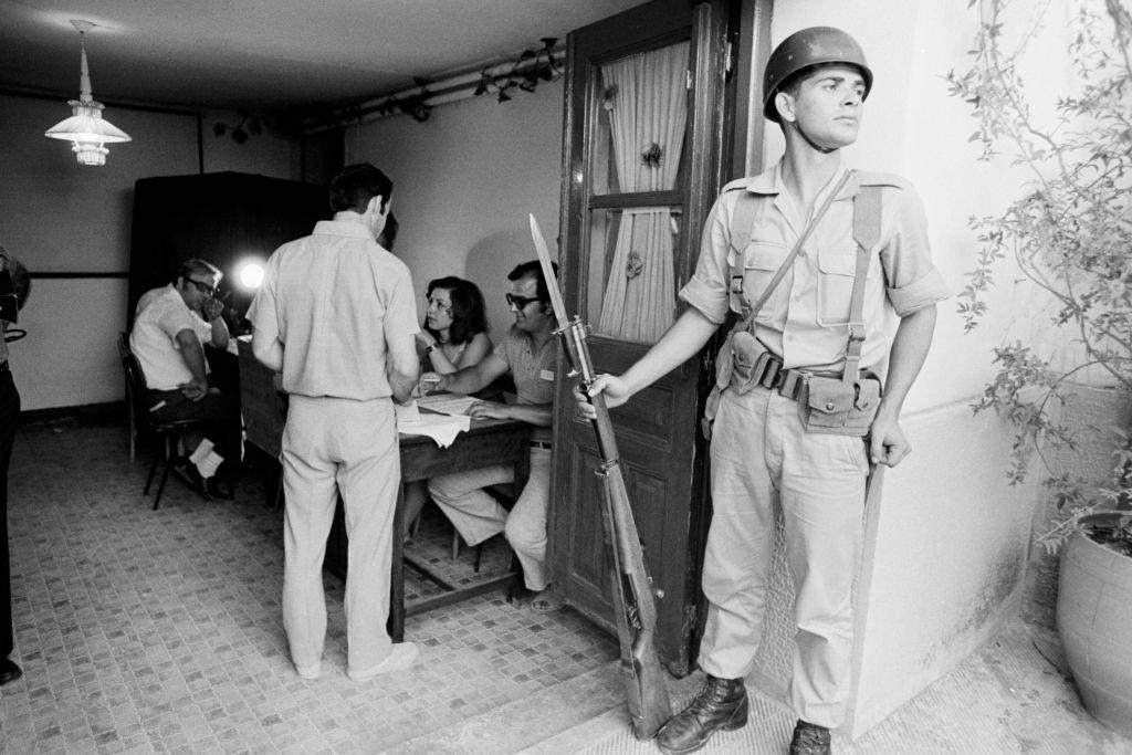 Voters in a polling station watched by a soldier during a referendum to abolish the monarchy and establish a republic, Athens July 29, 1973, Greece.