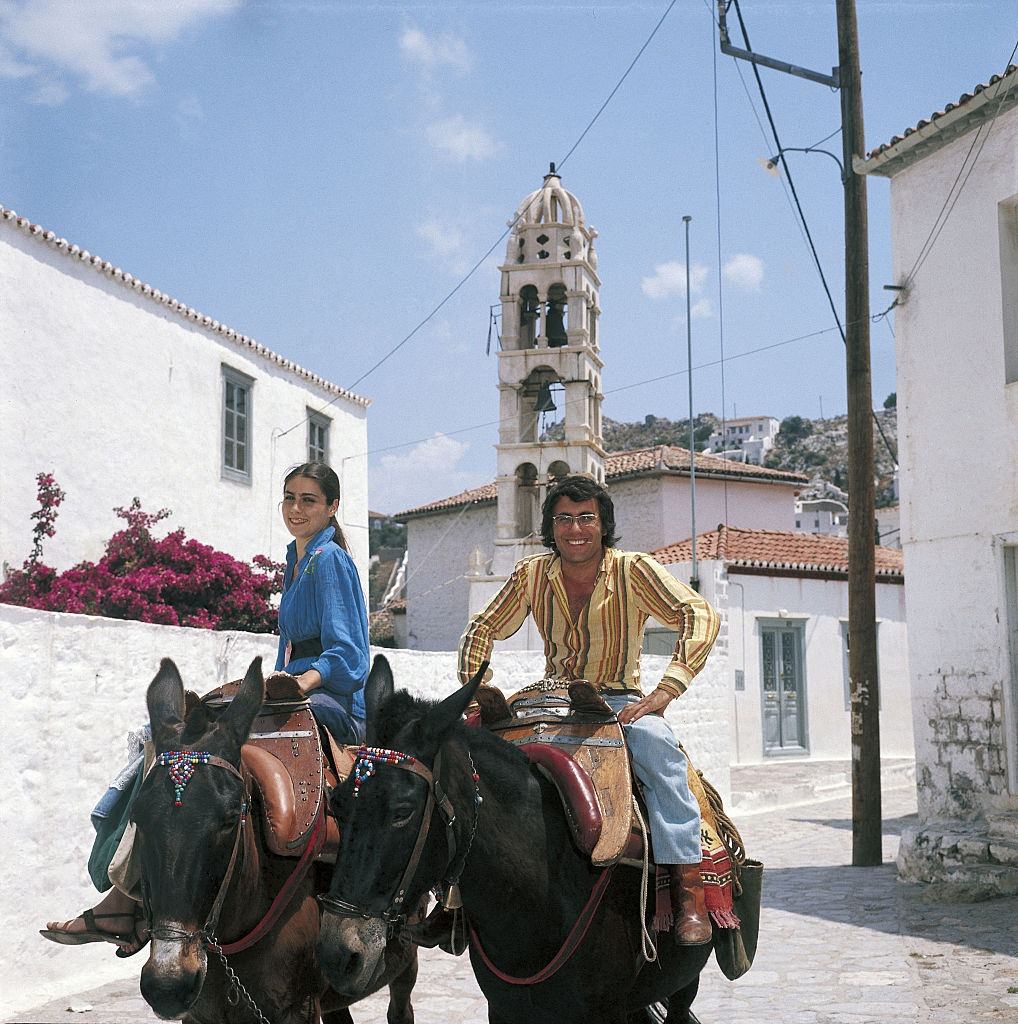 The Italian singer Al Bano, born Albano Carrisi, smiles with his wife Romina Power riding a mule. Greece, 1975