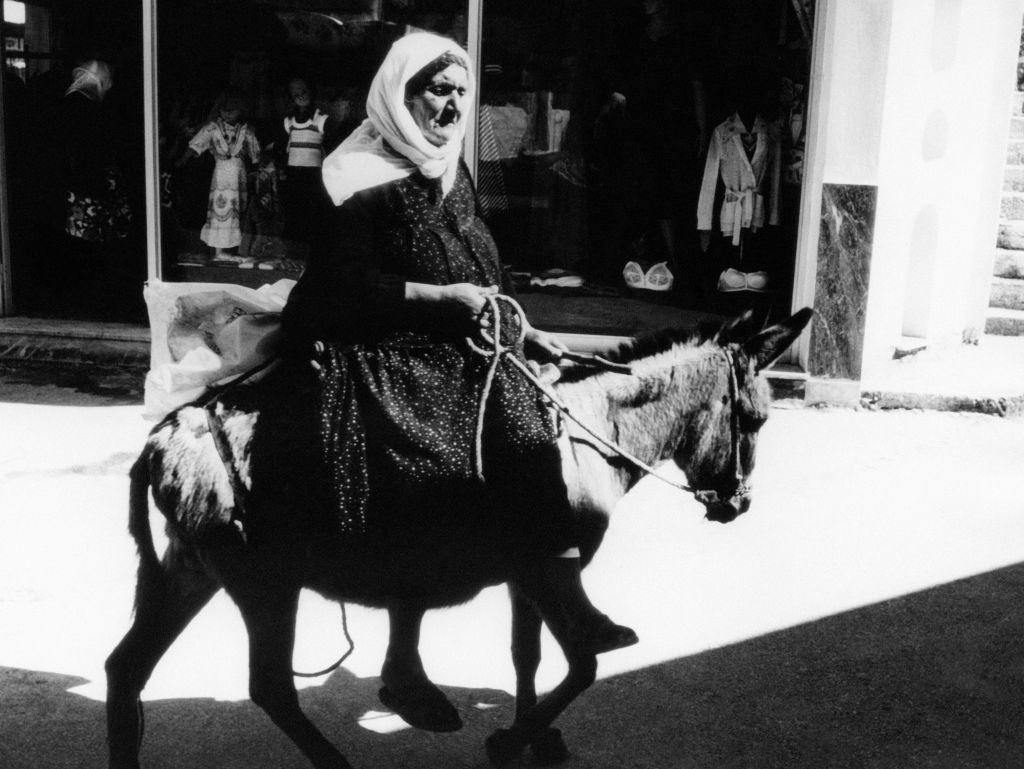 Woman moving on mule, on the island of Rhodes, Greece, in 1978.