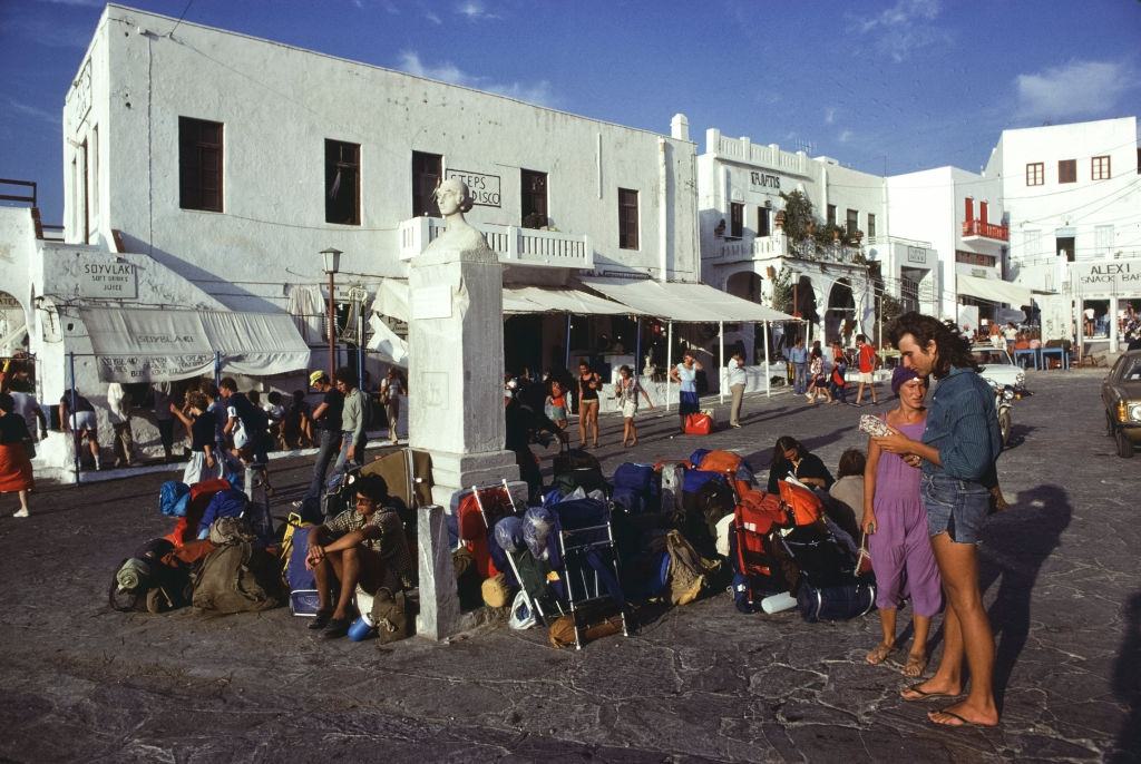 Tourists in a small village square on the island of Mykonos, September 1978 .