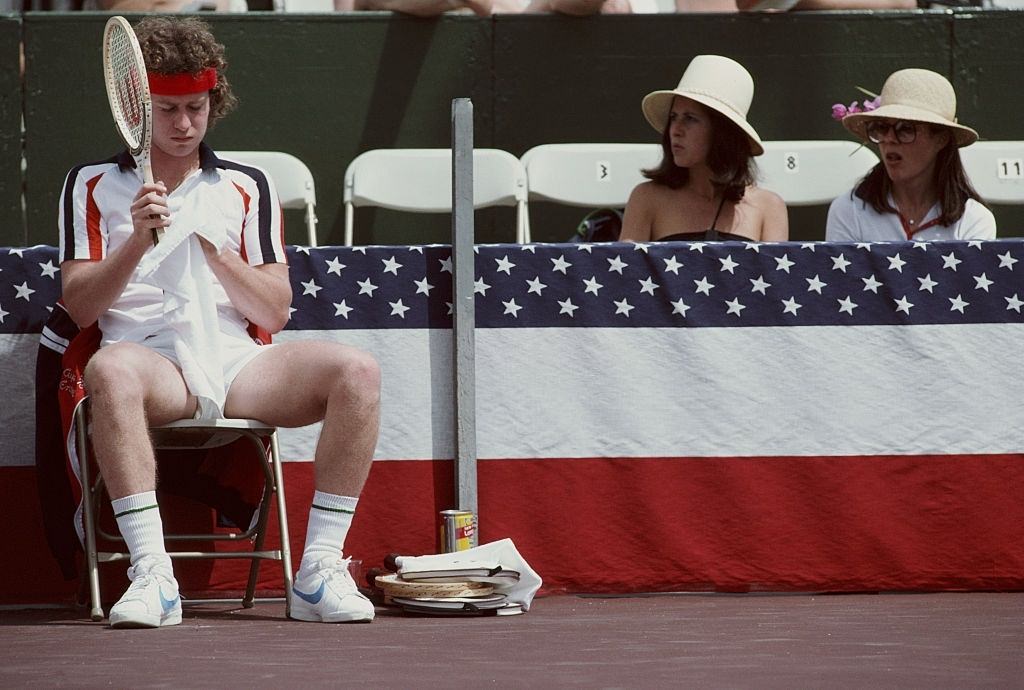 Two female spectators looking at John McEnroe of the United States during the Alan King Tennis Classic on 23 April 1979 at Las Vegas.