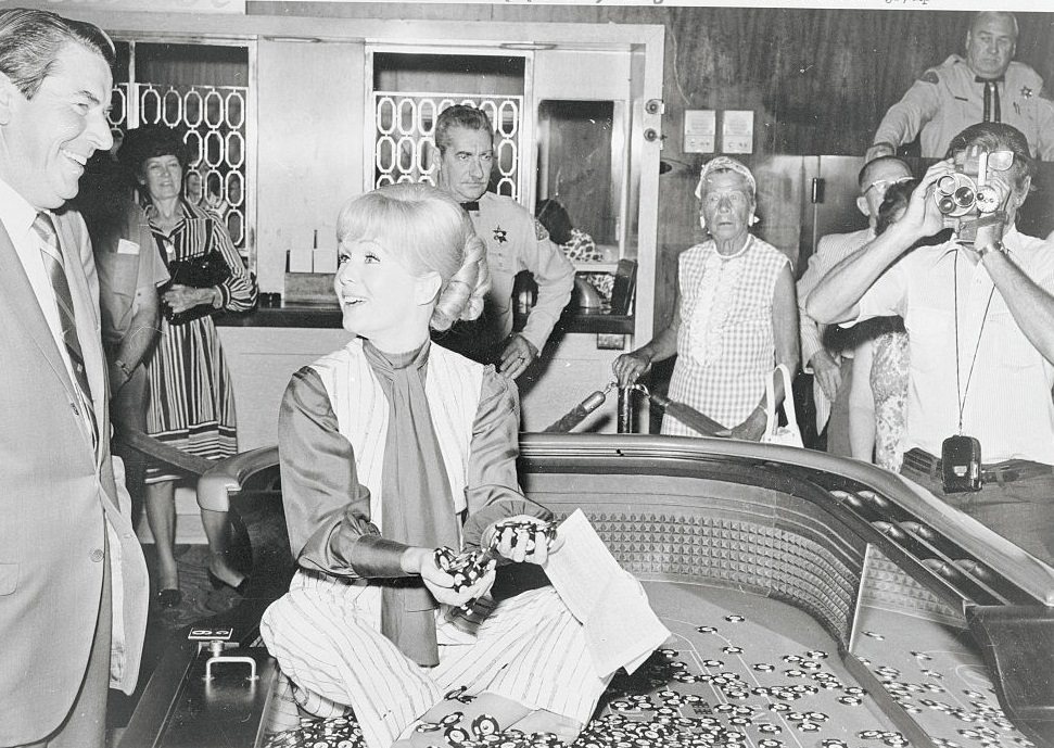 Actress Debbie Reynolds, seated on a craps table in the Desert Inn in Las Vegas, 1971.