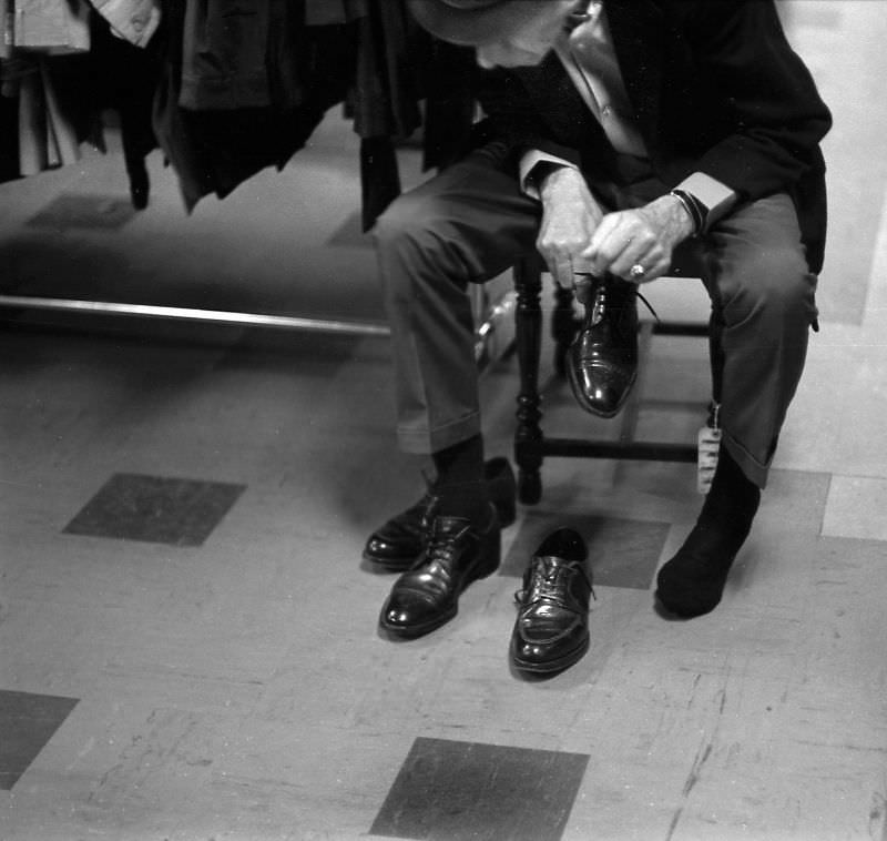 Man trying on shoes at the Salvation Army store on Howard and 6th Street, San Francisco, 1970
