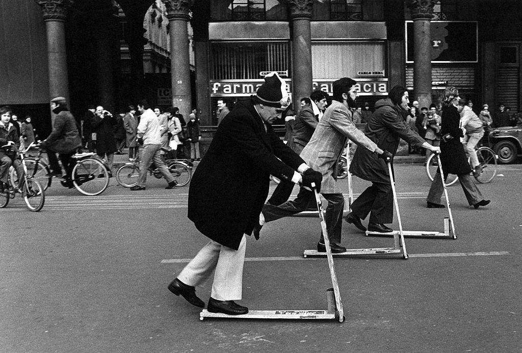 People riding kick scooters on Piazza del Duomo in Milan, December 1973.