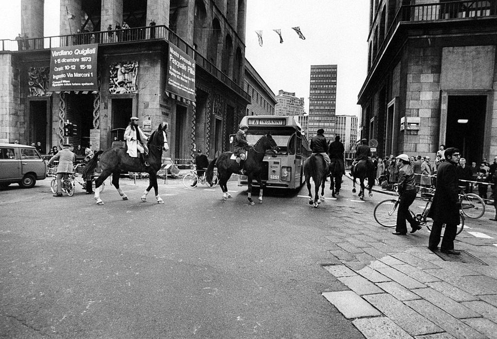 People riding horses on piazza del Duomo in Milan during the oil crisis.