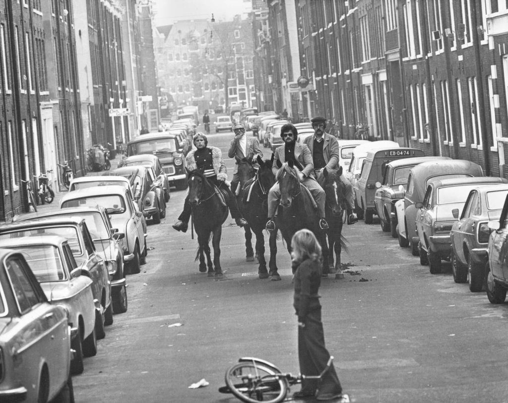 Four horsemen riding through the streets of Amsterdam on a 'motorless day', when cars are prohibited due to the oil crisis, November 1973.