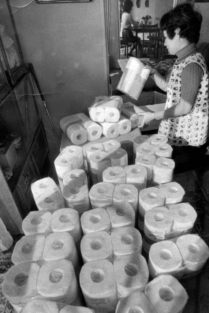 A woman purchases amounts of toilet rolls as oil crisis, Japan.